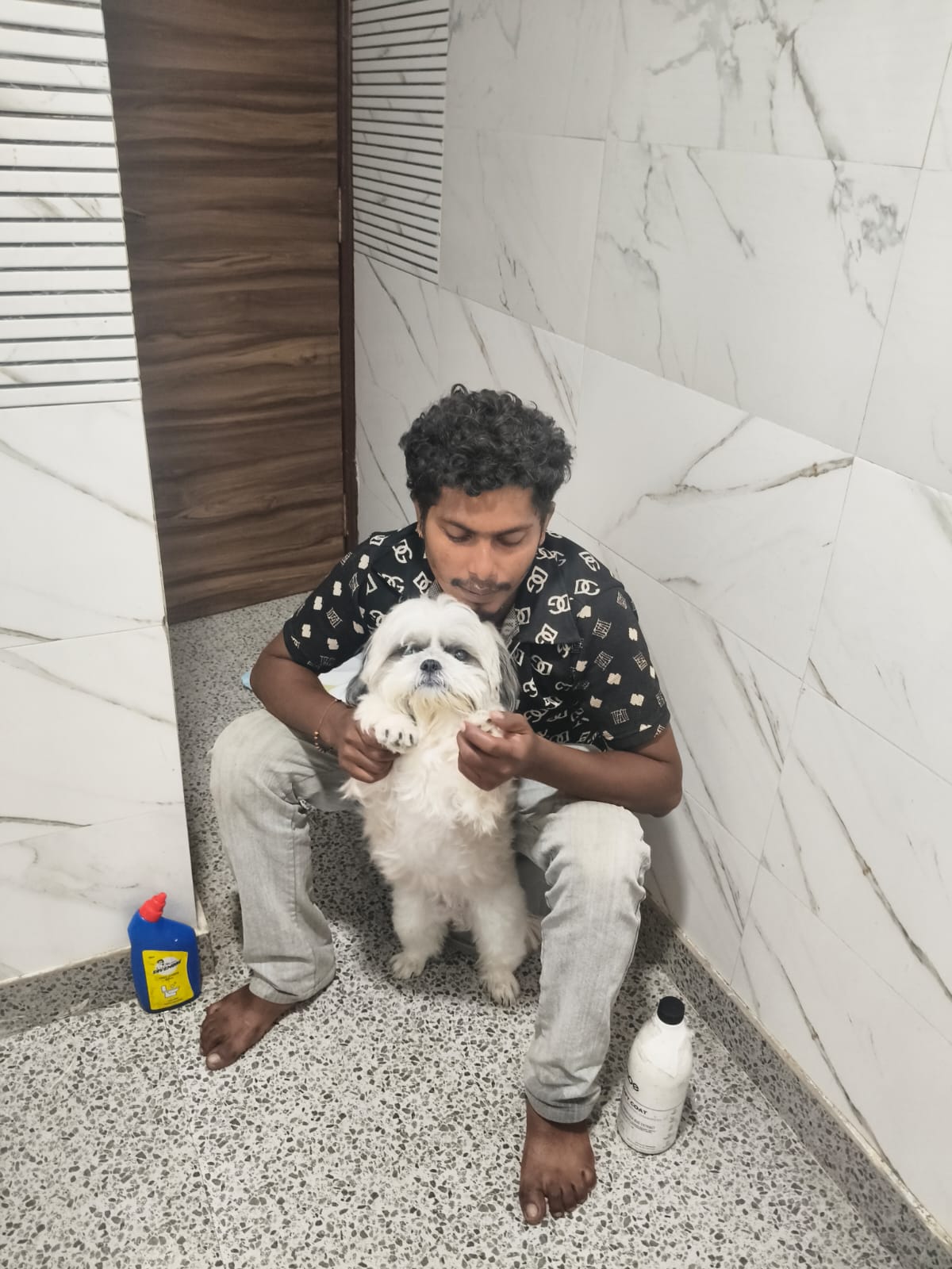 Loving handler cuddling and caring for freshly bathed companion